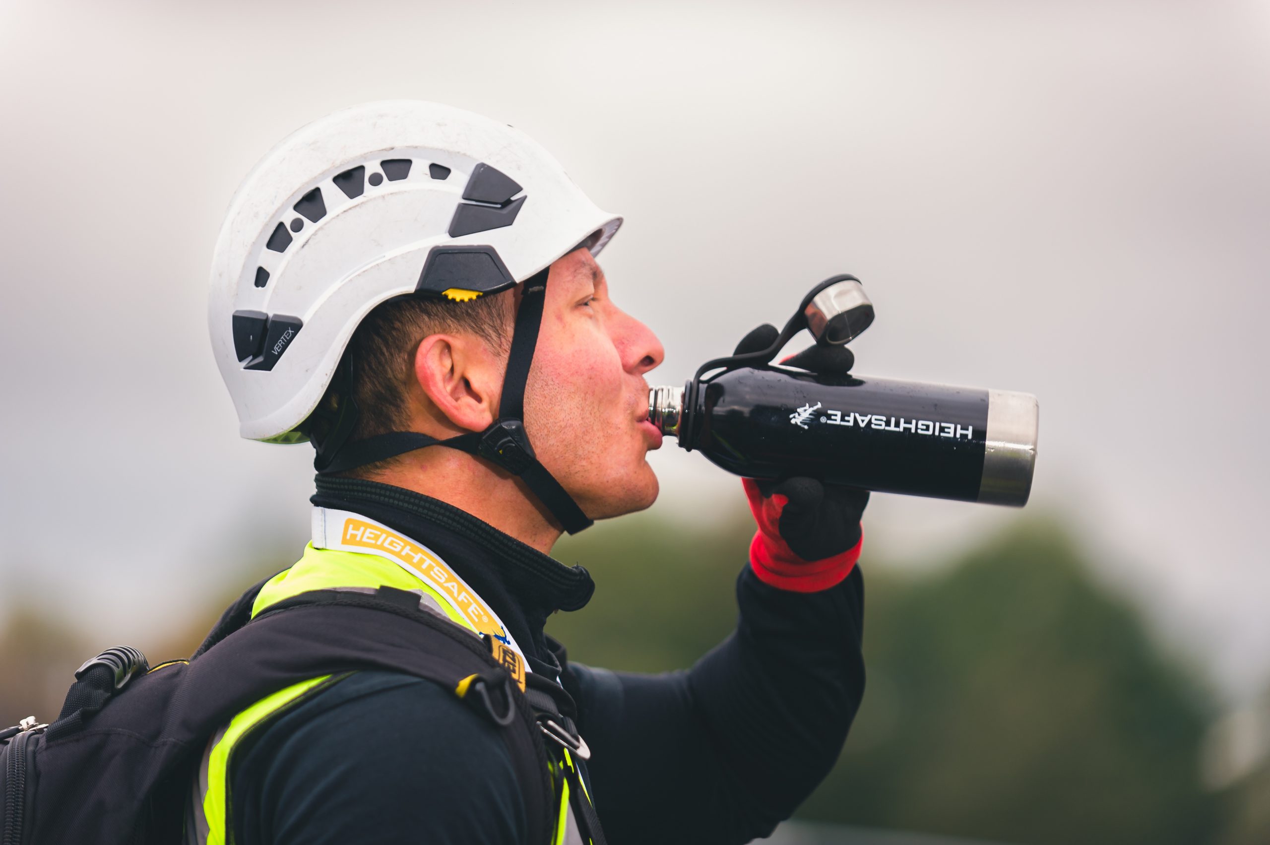 Heightsafe engineer drinking from a Heightsafe water bottle
