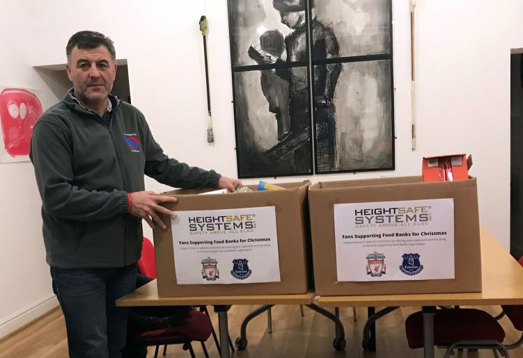 Ian Byrne of Fans Supporting Food Banks Accepting Heightsafe's Donation