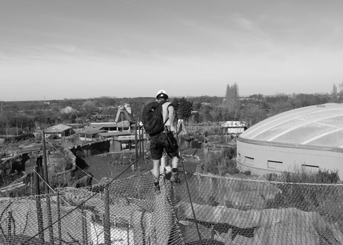 Man on safety net over zoo enclosure