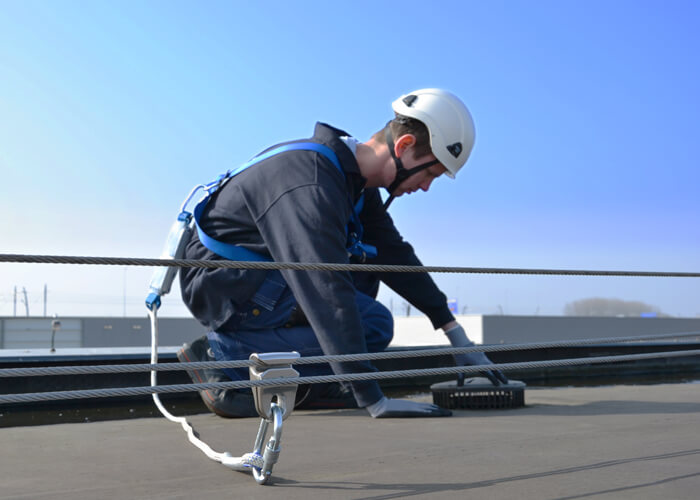 Man Working at Height Safely whilst attached to a specialist personal fall protection Safety Line