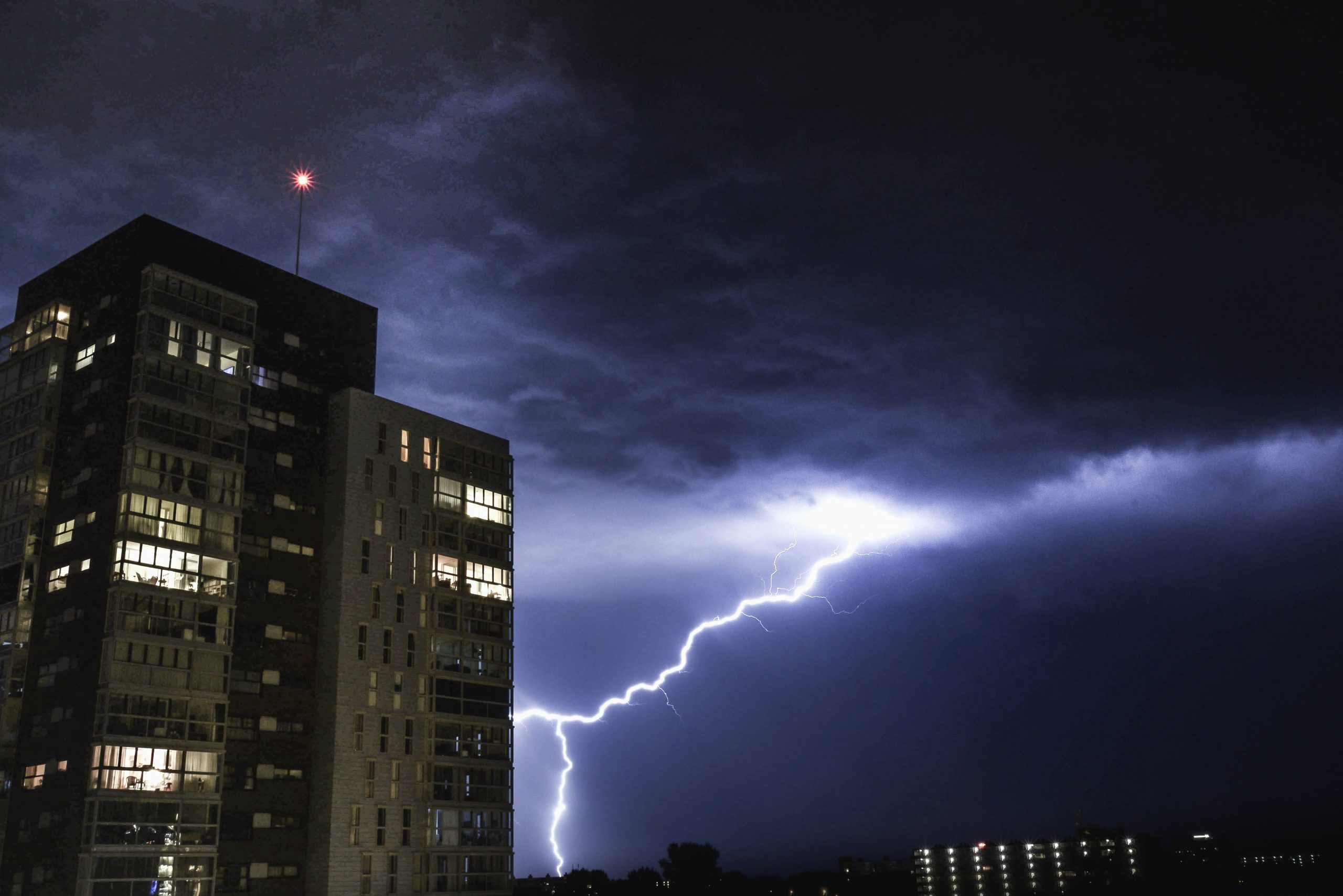 Lightning next to high rise building